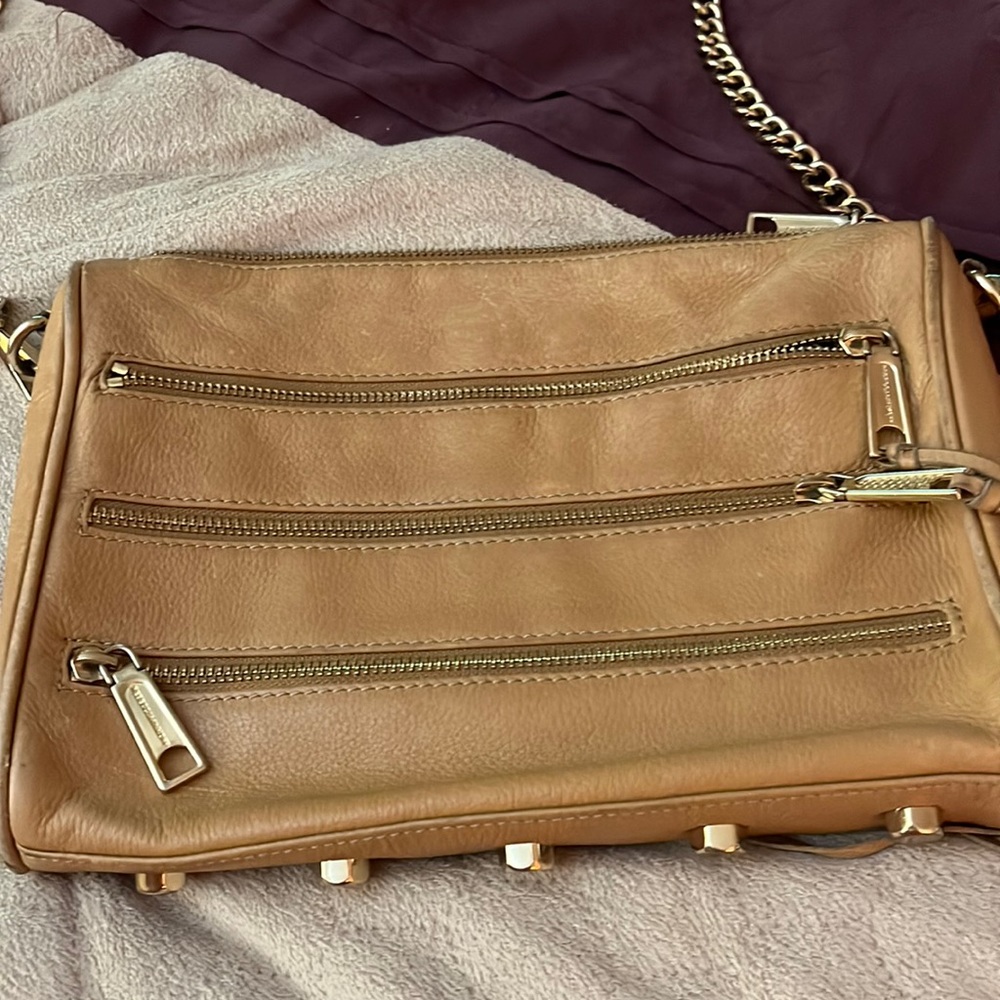 Tan leather Rebecca minkoff bag with chain strap. Lots of pockets. Slightly worn